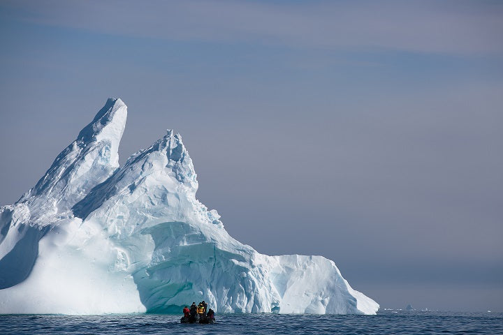 Exploring the iceberg graveyards near Vernadsky Station (Ukranian station that discovered the ozone hole. For perspective, the boat is several hundred meters away from the iceberg.