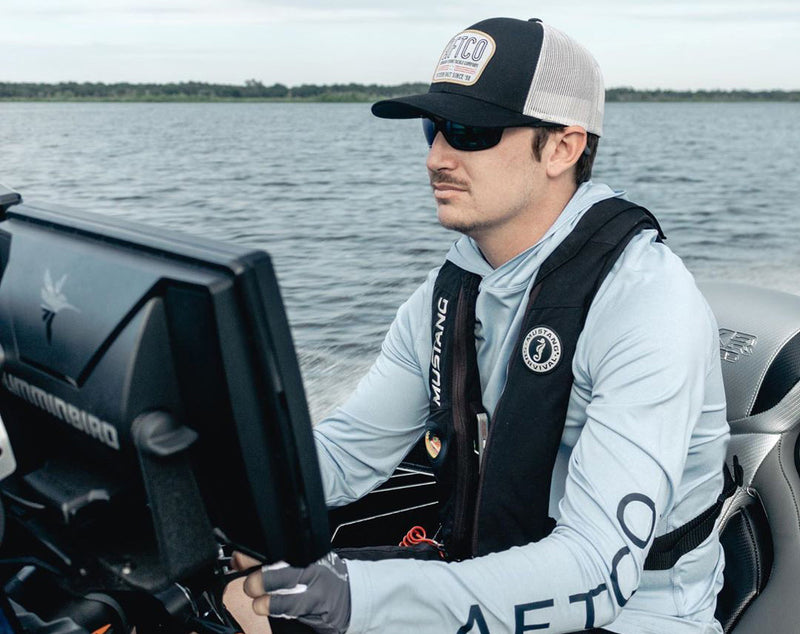 fishing bass, hunter bland wearing a mustang survival PFD