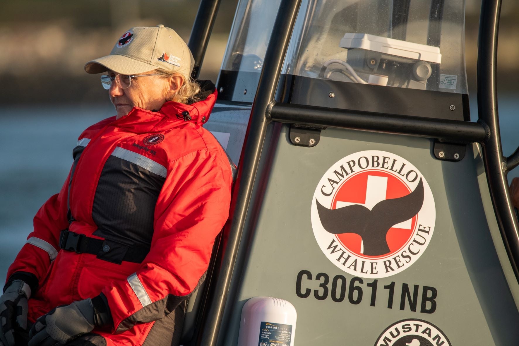 Senior Scientist Moira Brown wearing Mustang Survival Flotation Clothing