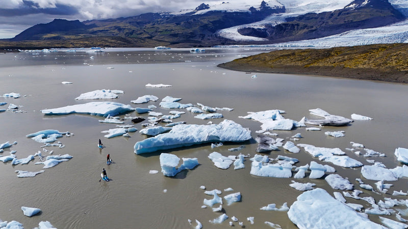Mother, daughter and son stand up paddle board through the icebergs of Iceland in Mustang Survival Hudson and Helix drysuits