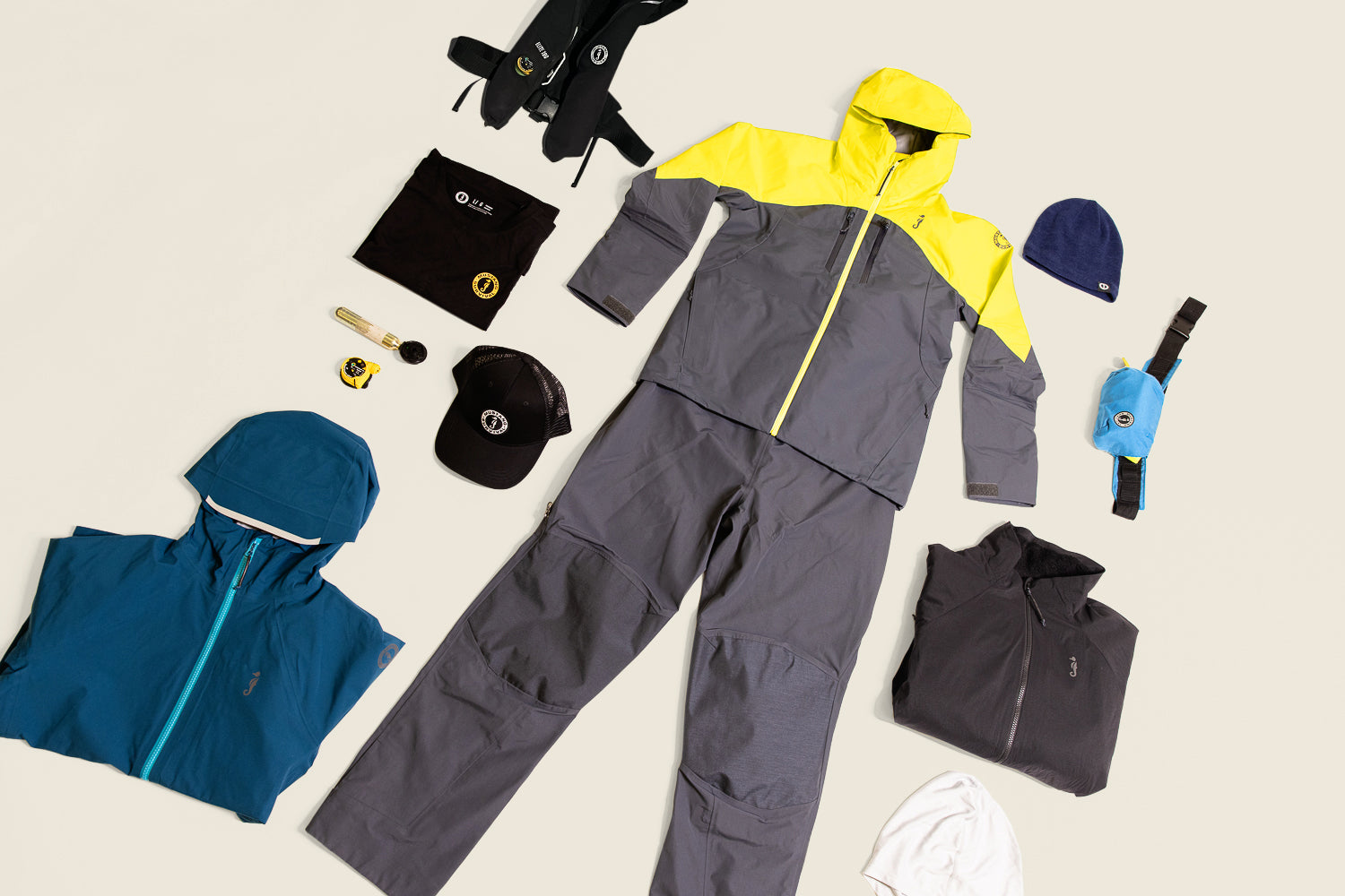 Mustang Survival gear laid out for holiday gifts for women, featuring Taku waterproof layers, PFDs, and accessories.
