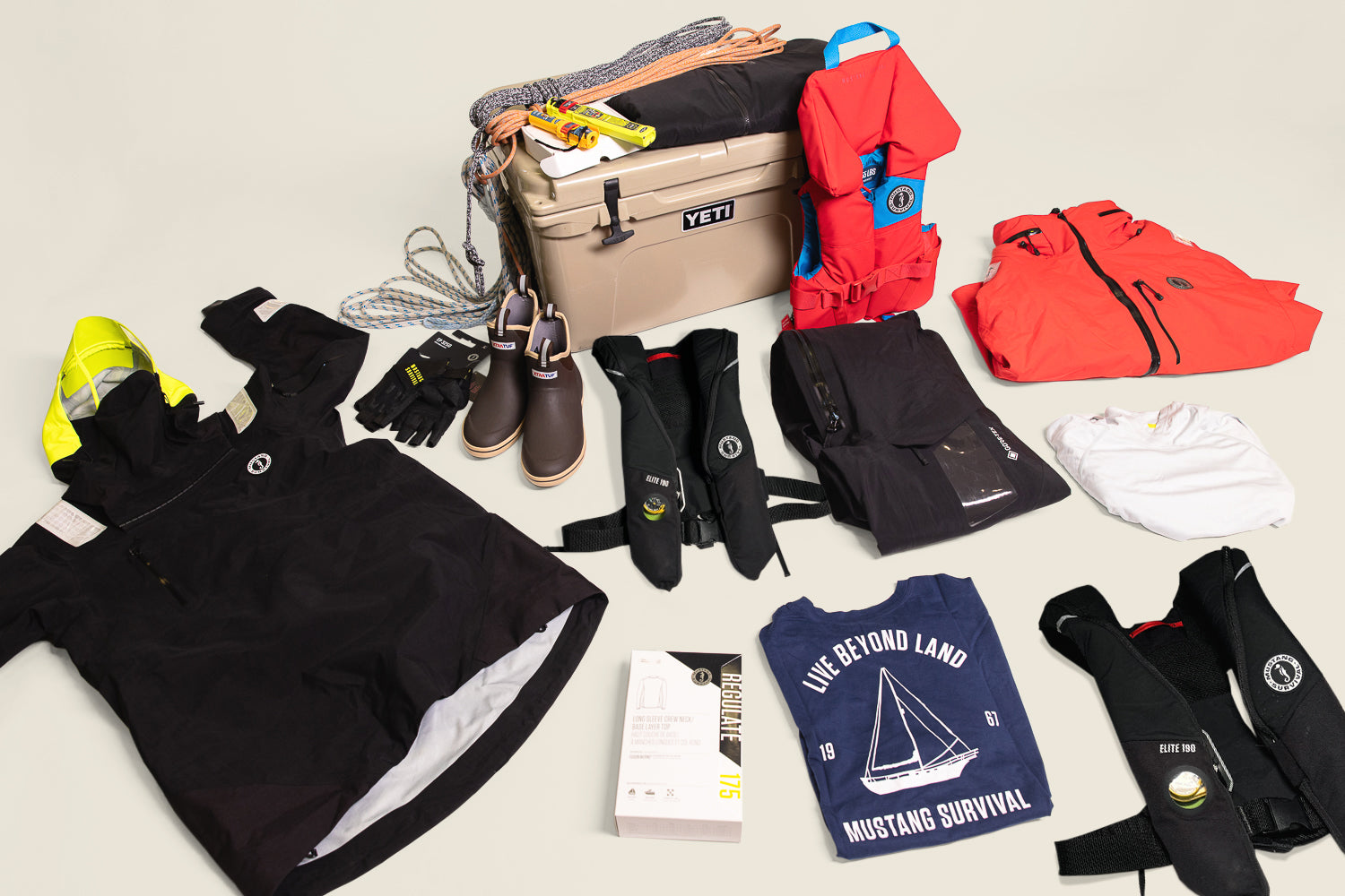 Mustang Survival sailing gear laid out for holiday gifts for sailors, featuring EP Collection, PFDs, and accessories.