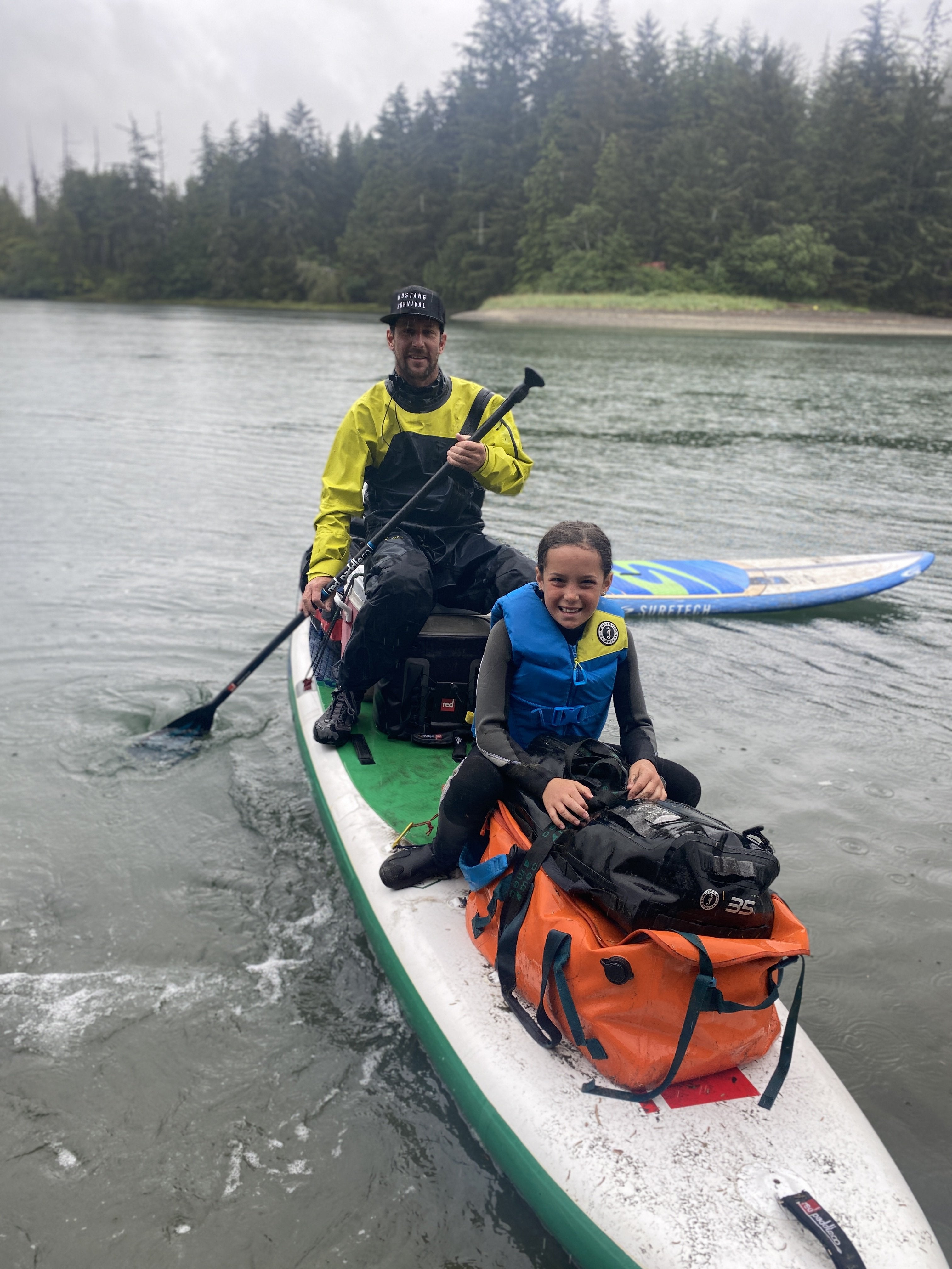 jimmy martinello on a sup with a kid