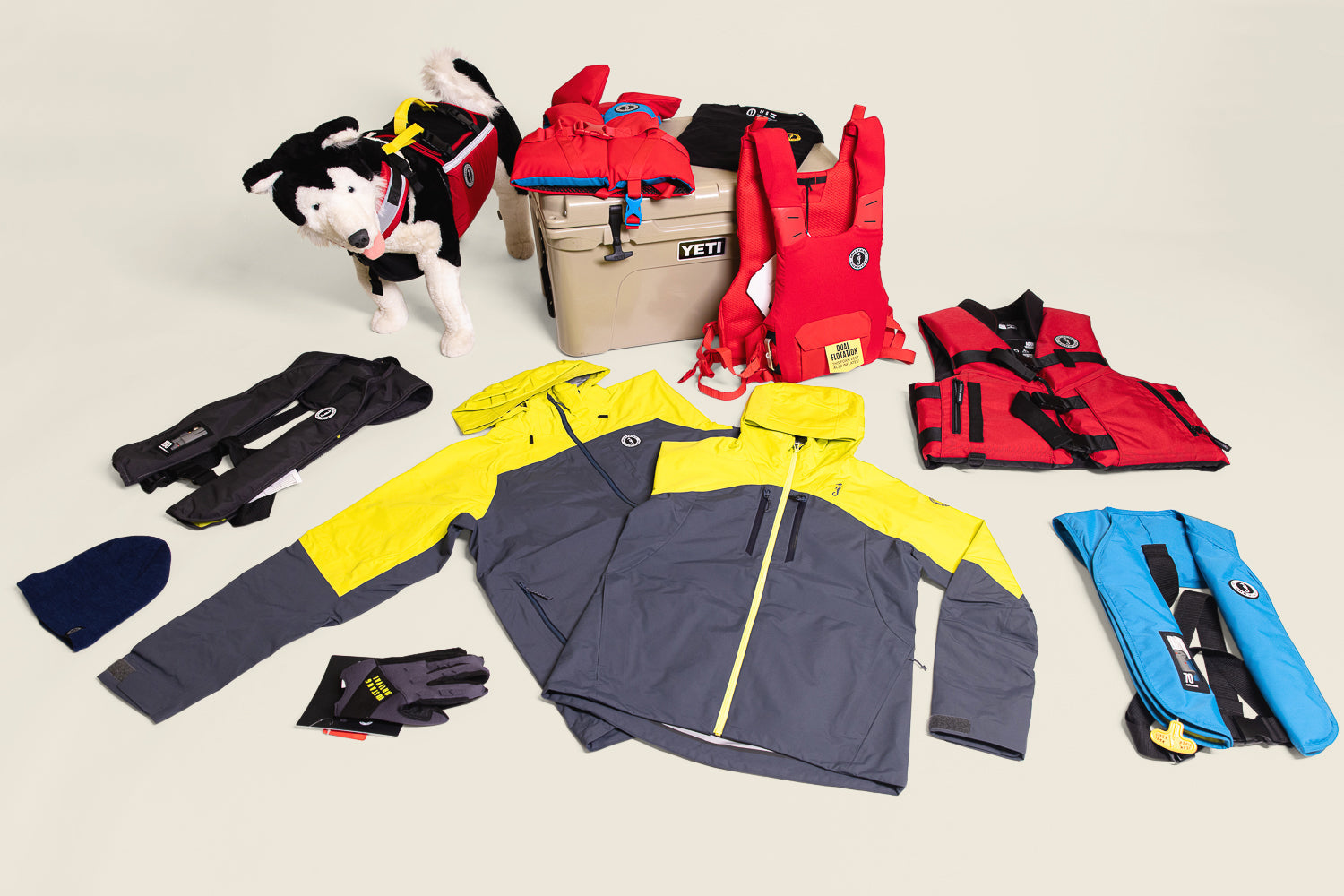 Mustang Survival boating gear laid out for holiday gifts for boaters, featuring Taku jackets, PFDs, and layers.