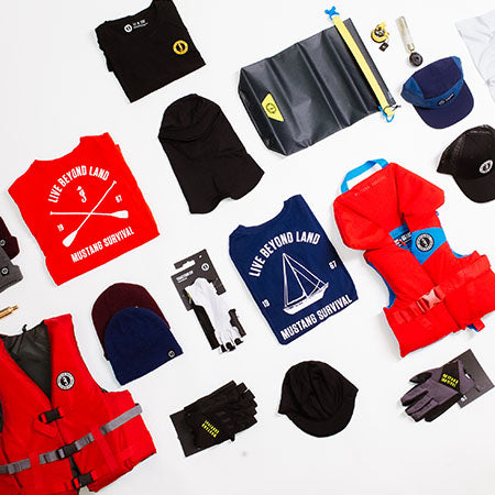 Mustang Survival gear under $100 laid out, featuring stocking stuffers like belt packs, hats, and small accessories.