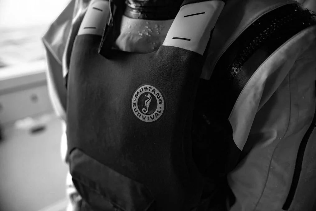 Close-up of the khimera life jacket with a visible Mustang Survival logo on a boat.